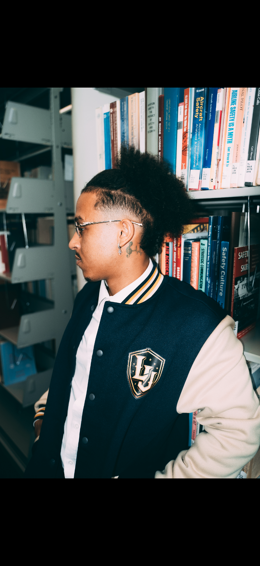 Close-up of the embroidered LU crest on the Legends University varsity jacket